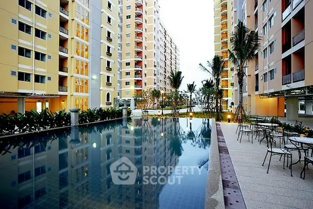 Luxurious apartment complex with stunning pool and modern architecture.