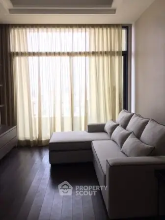 Elegant living room with large window and modern sofa, perfect for relaxation.