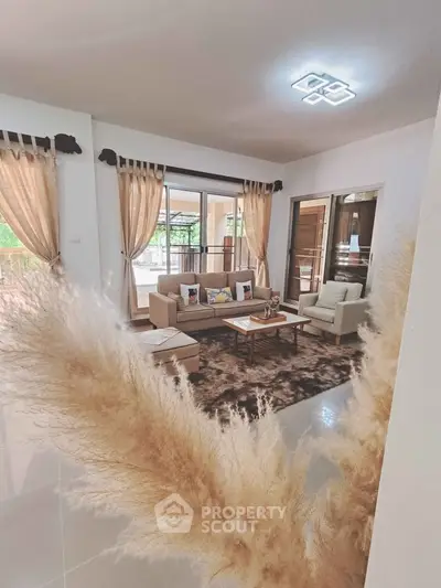 Spacious living room with modern decor and large windows offering natural light.