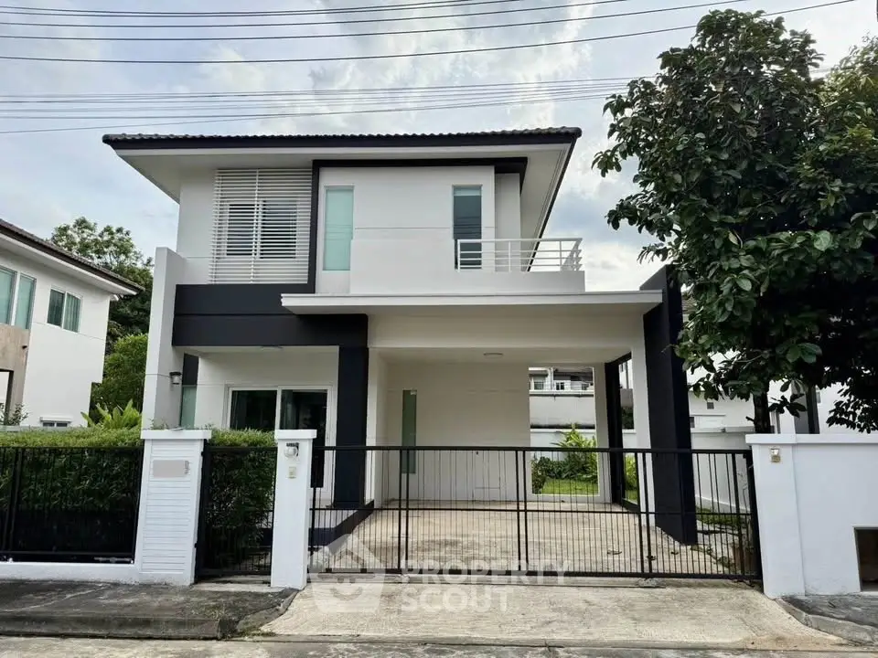 Modern two-story house with sleek design and spacious driveway in a serene neighborhood.