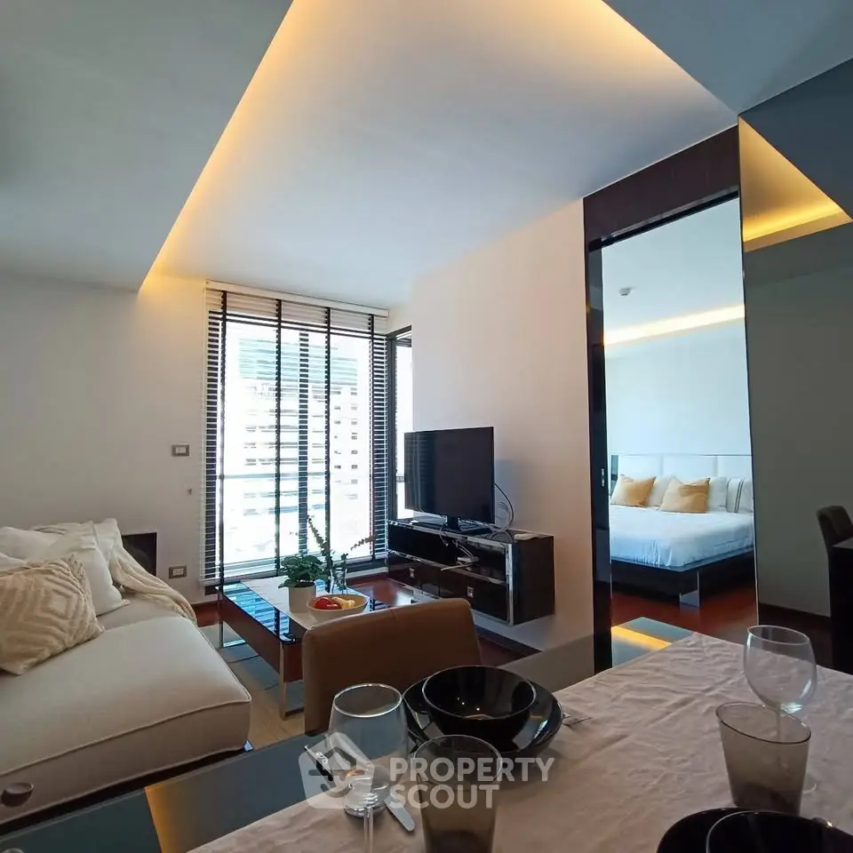 Modern living room with elegant decor and city view, featuring a cozy sofa and stylish dining area.