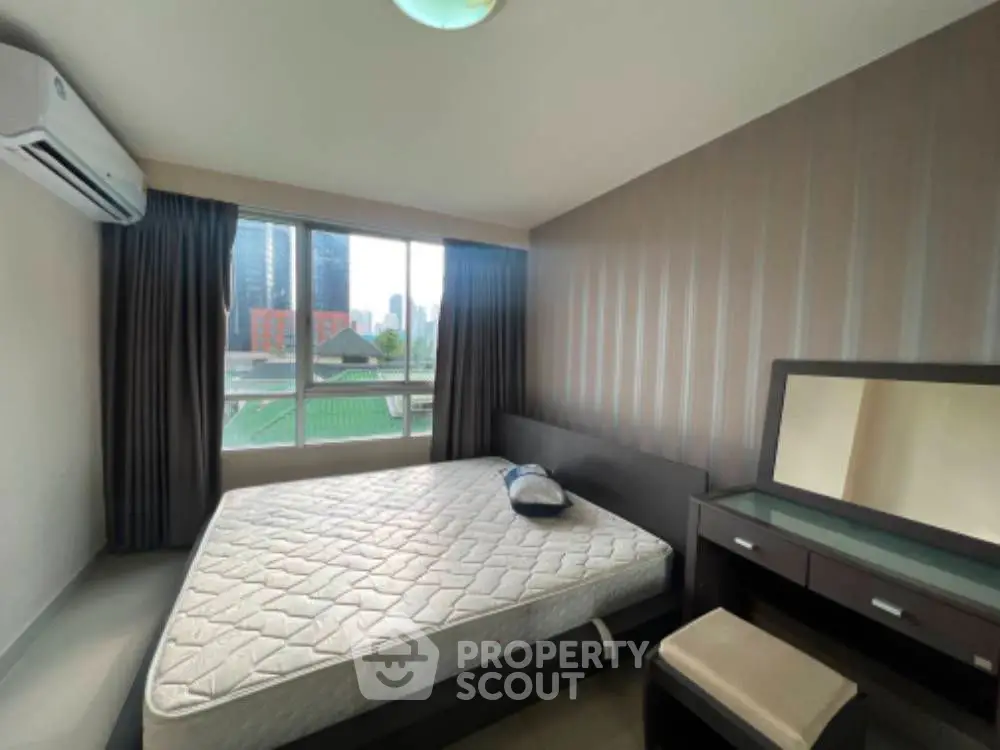 Modern bedroom with large windows and stylish furniture