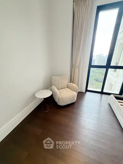 Cozy corner with plush armchair and city view in modern apartment