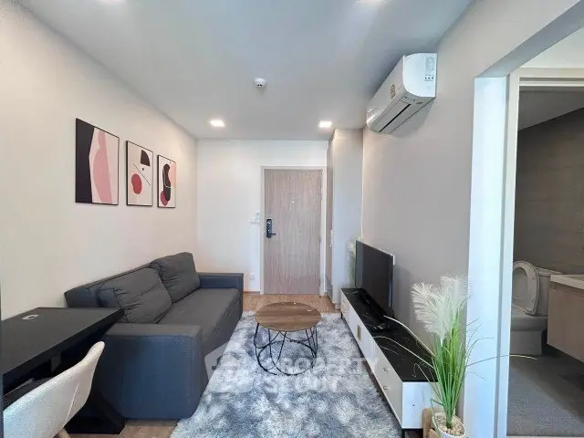 Modern living room with stylish decor and air conditioning in a cozy apartment.