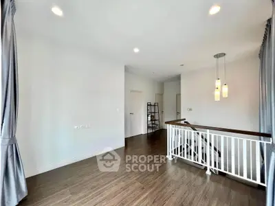 Spacious modern interior with elegant lighting and wooden flooring, perfect for stylish living.