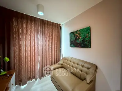 Cozy living room with elegant sofa and artistic wall decor, perfect for relaxation.