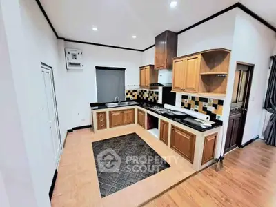 Modern kitchen with stylish cabinetry and tiled backsplash in a spacious layout.