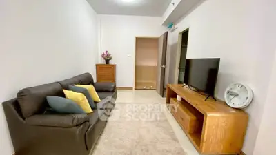 Cozy living room with modern sofa and TV unit, perfect for relaxation.