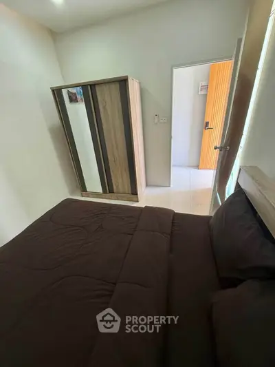 Cozy bedroom with modern wardrobe and stylish bedding