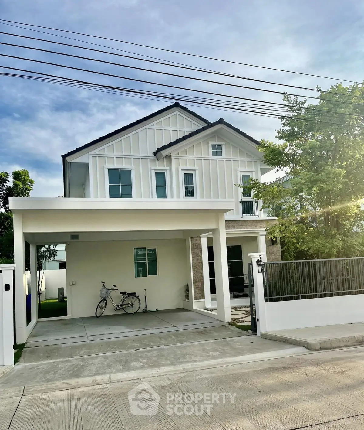 Charming two-story house with modern facade and spacious driveway in a serene neighborhood.