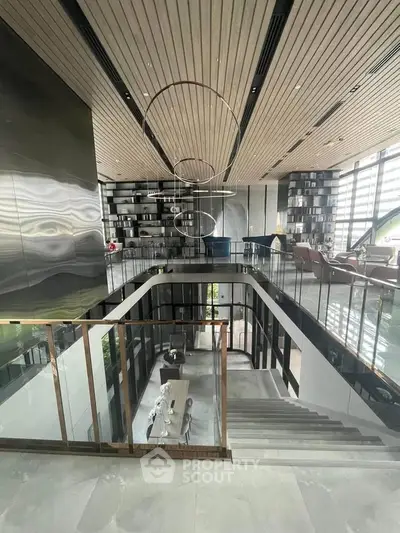 Luxurious modern living room with high ceilings and elegant staircase