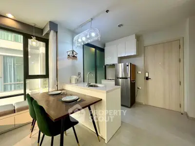 Modern kitchen with sleek design, featuring stainless steel appliances and a cozy dining area with natural light.