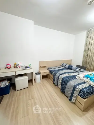 Spacious bedroom with twin beds and modern decor in a cozy apartment.