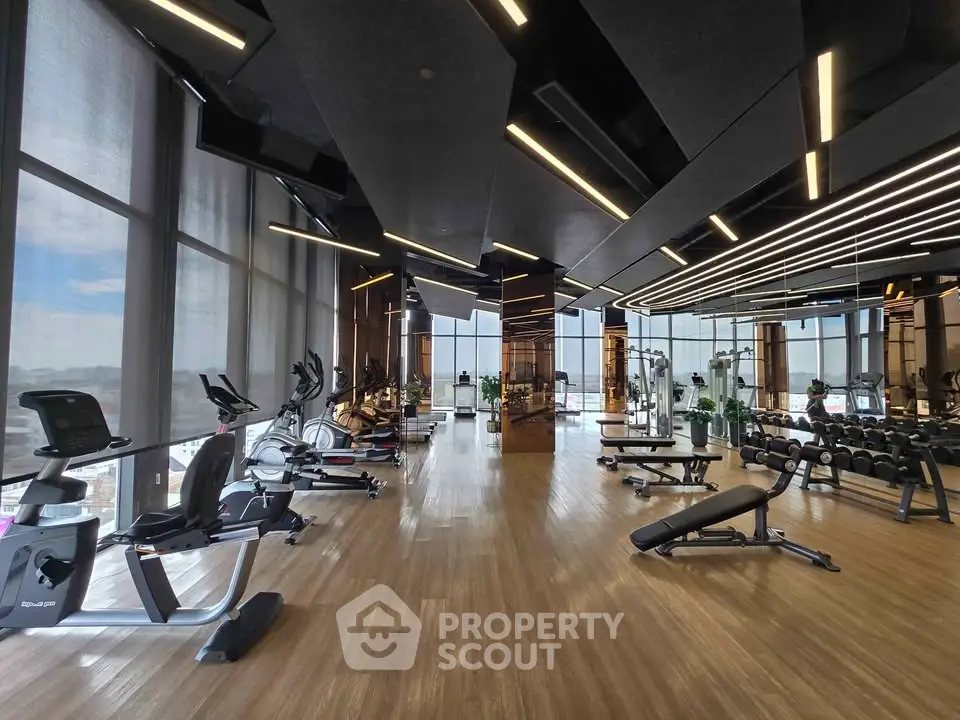 Luxurious modern gym with state-of-the-art equipment and panoramic city views.