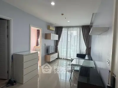 Modern living room with sleek furniture and large windows in a stylish apartment.
