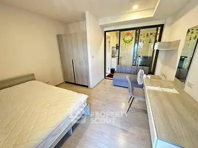Modern bedroom with stylish furniture and natural light, featuring a cozy workspace and sleek design.