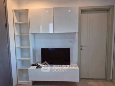Modern living room with sleek TV unit and storage shelves, perfect for contemporary urban living.