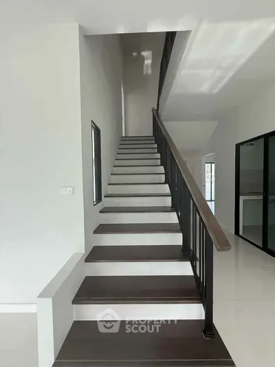 Modern interior staircase with sleek design and natural lighting