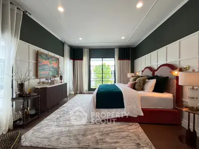 Luxurious bedroom with elegant decor and large windows offering natural light and a serene view.