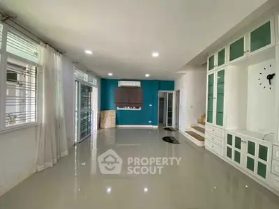 Spacious living room with modern built-in storage and large windows for natural light.