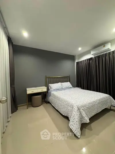 Modern bedroom with stylish decor and cozy ambiance, featuring a comfortable bed and elegant furnishings.