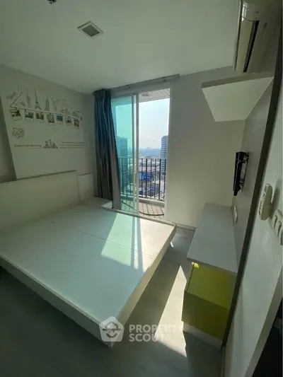 Modern bedroom with balcony view in high-rise apartment, featuring sleek design and ample natural light.