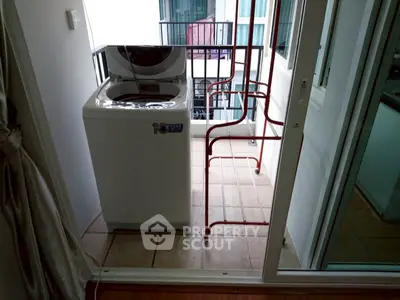 Compact balcony with washing machine and drying rack in modern apartment