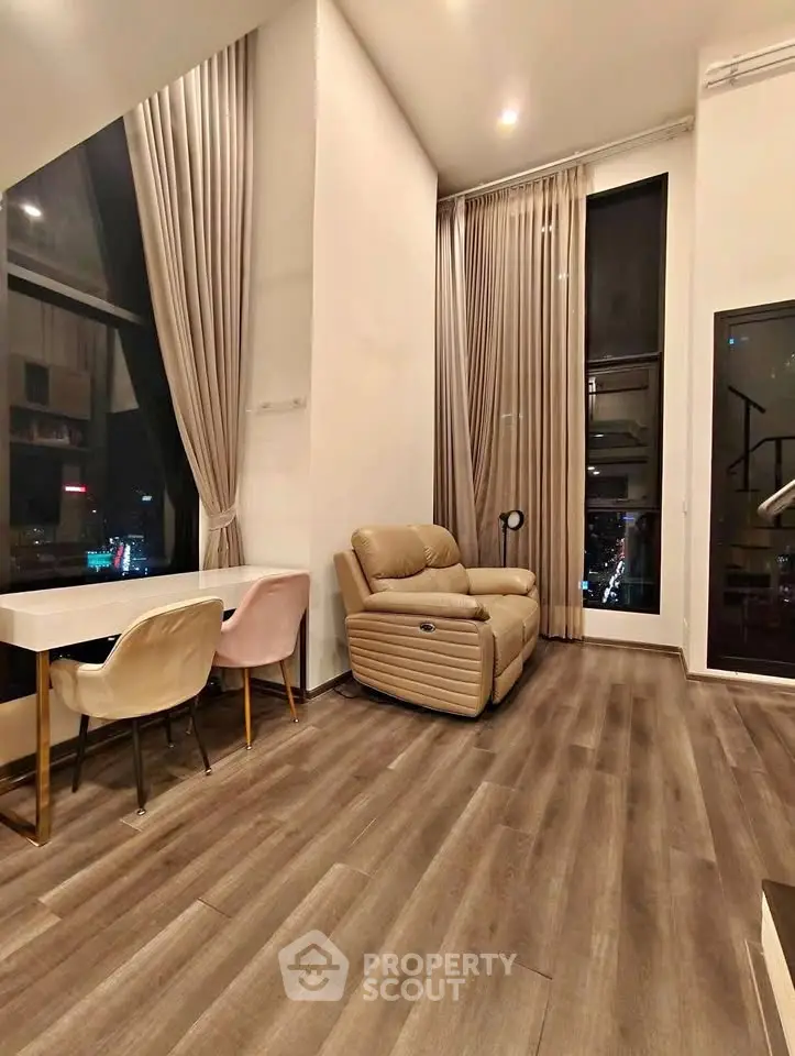 Luxurious high-ceiling living room with elegant decor and city view