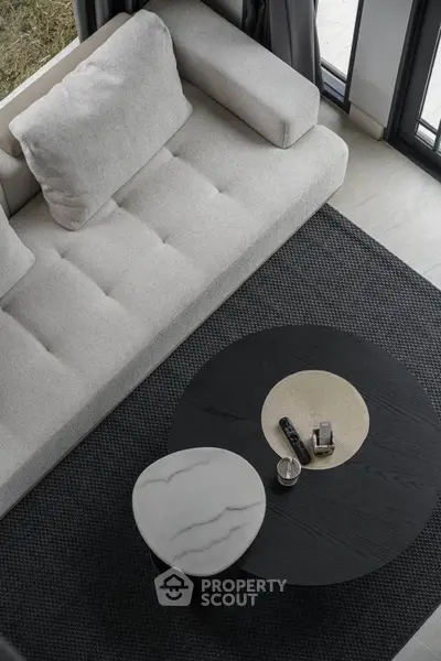 Modern living room with stylish sofa and elegant coffee table in a chic interior setting.