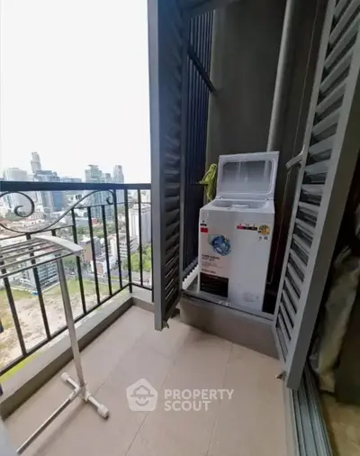 High-rise balcony with city view and washing machine, perfect for urban living.