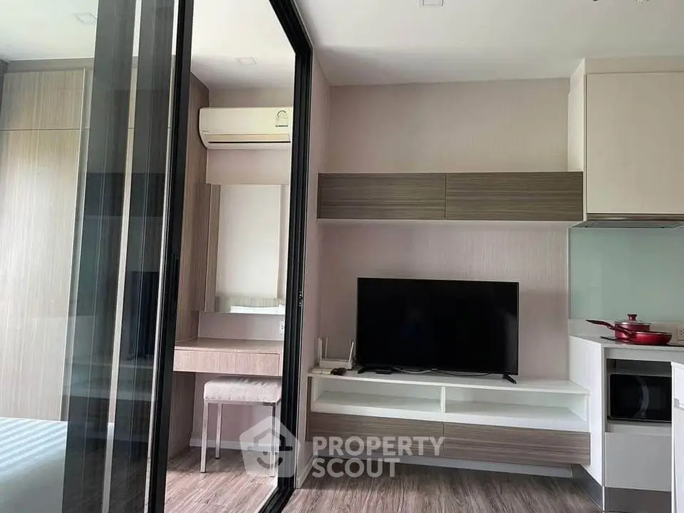 Modern living room with TV and air conditioning in stylish apartment.