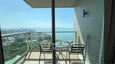 Stunning balcony with panoramic ocean view and modern outdoor seating.