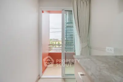 Modern apartment balcony with sliding glass door and city view