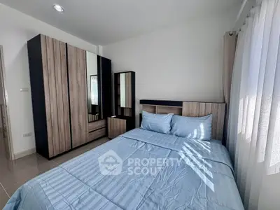 Modern bedroom with stylish wooden wardrobe and cozy blue bedding
