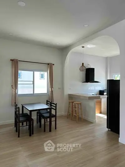 Modern dining area with open kitchen layout and natural light