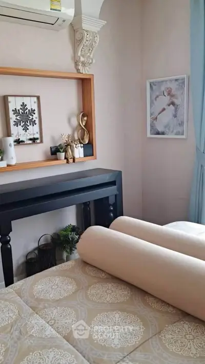 Cozy bedroom with elegant decor and soft lighting, featuring a stylish wall shelf and decorative art pieces.