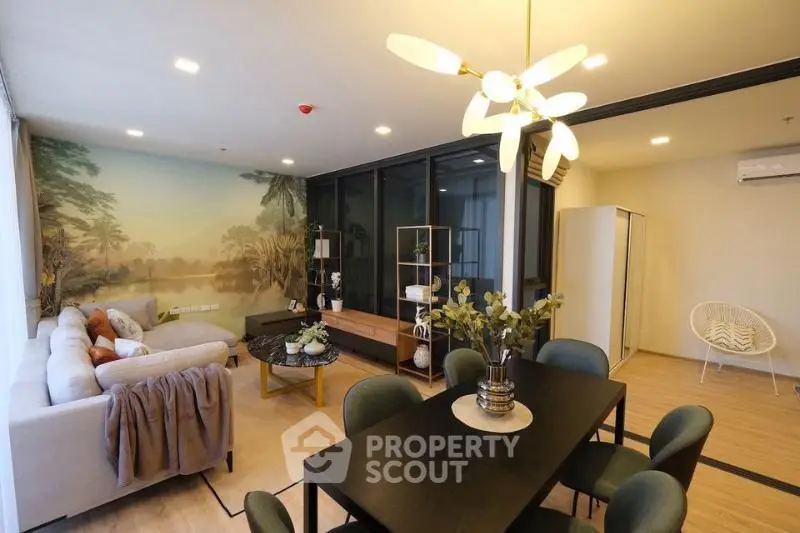 Spacious modern living room with elegant dining area and scenic wall mural, perfect for stylish urban living.