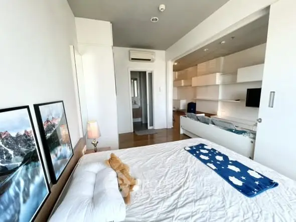 Modern bedroom with stylish decor and open layout in a contemporary apartment.