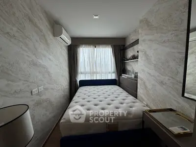 Cozy bedroom with modern decor and natural light, featuring a comfortable bed and stylish wall accents.