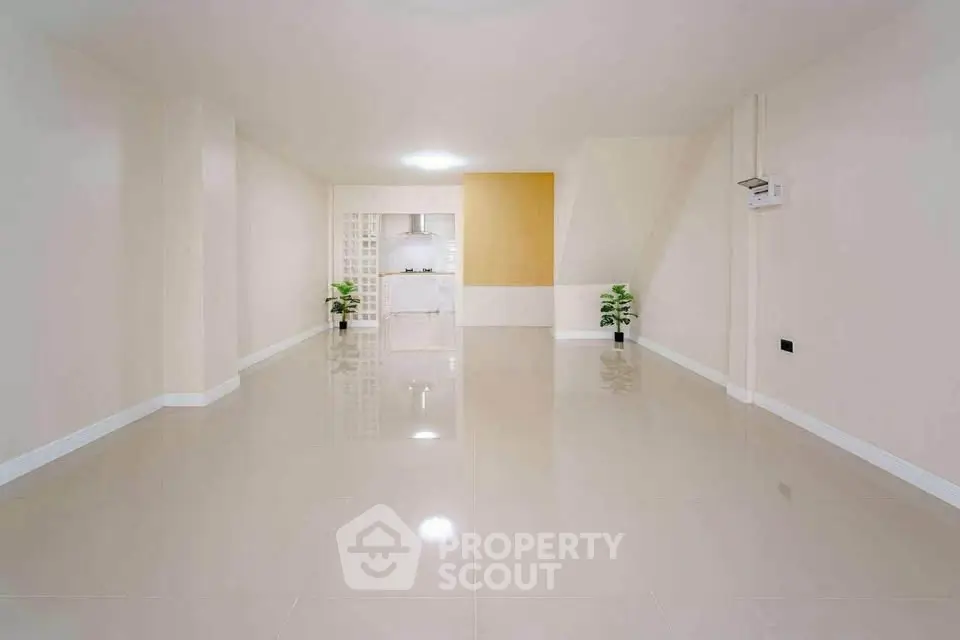 Spacious modern living room with glossy tile flooring and minimalist decor