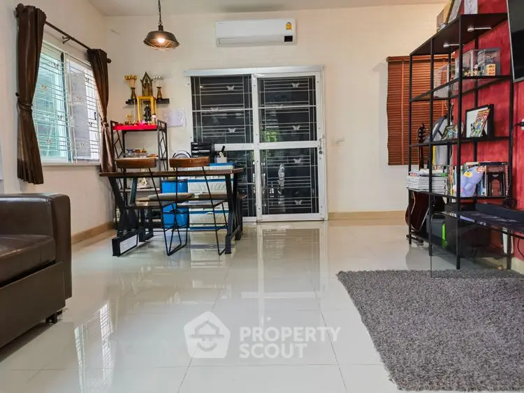 Modern living room with sleek furniture and large windows for natural light.