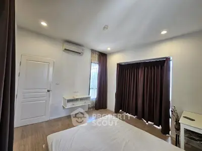 Spacious bedroom with modern decor and natural light