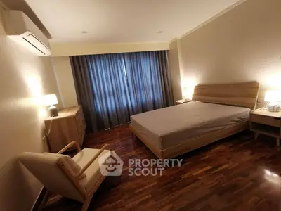 Spacious bedroom with modern wooden furniture and elegant lighting