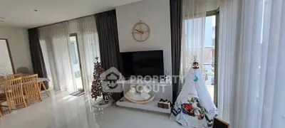 Spacious living room with modern decor and large windows