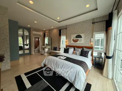 Luxurious bedroom with modern decor and large windows for natural light.