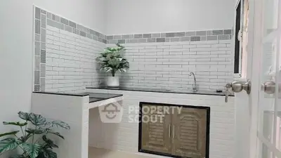 Charming kitchen with modern tile backsplash and sleek countertop