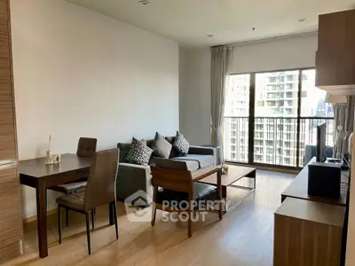 Modern living room with city view, stylish furniture, and large windows in a high-rise apartment.