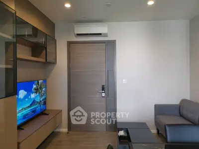 Modern living room with sleek furniture and wall-mounted TV