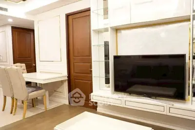 Elegant living room with modern TV unit and dining area