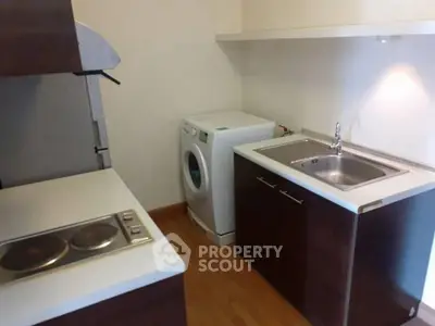 Compact kitchen with washing machine and electric stove